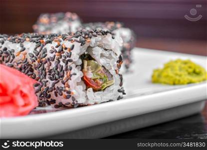 Closeup of Sushi rolls at plate with sesame