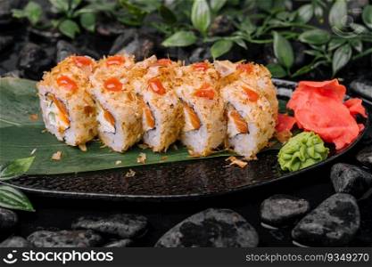Closeup of sushi rolls on black plate