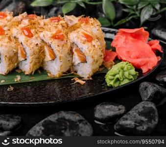 Closeup of sushi rolls on black plate