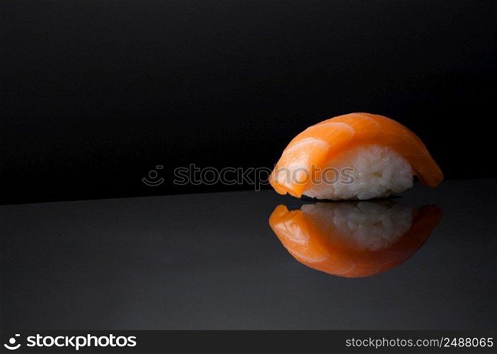 closeup of sushi with rice on grey  background with reflection. sushi on black background
