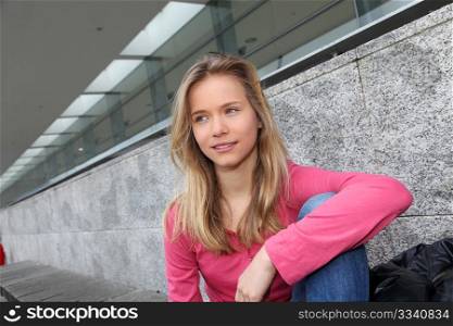 Closeup of teenage girl sitting on a school bench