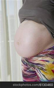 Closeup of the belly of pregnant woman at home