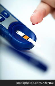 Closeup of the Diabetic Doing a Glucose Level Finger Blood Test