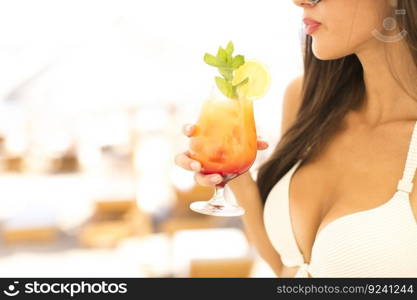 Closeup of the woman with the drink on the beach