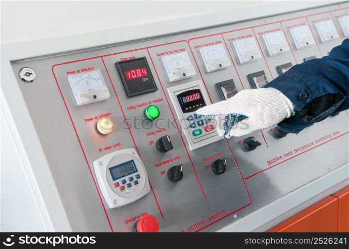 closeup of the working hand on the remote machine control. worker operates the machine from the control center. working hand on the remote machine control