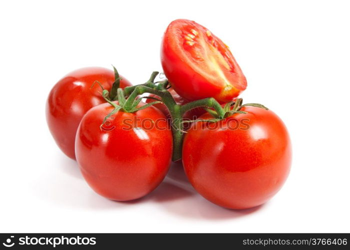 Closeup of tomatoes on the vine isolated on white. Tomato branch