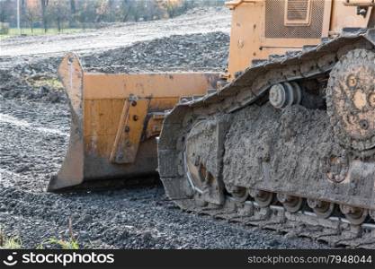 closeup of tracked loader excavator at stony quarry on a building site