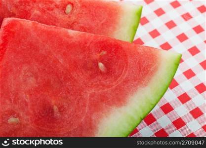 Closeup of two slices of juicy. red watermelon. Shallow depth of field.