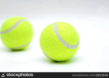 Closeup of two tennis balls isolated on white background.