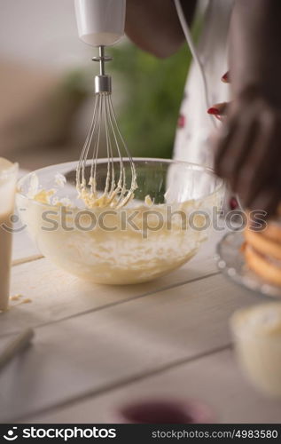 Closeup of two unrecognizable african girls cooking at home