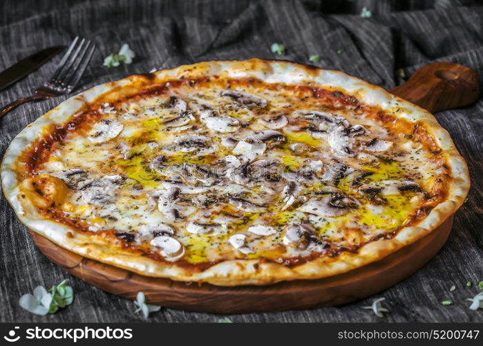 Closeup of Vegetariana Pizza on wooden table, mushrooms