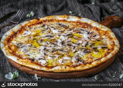 Closeup of Vegetariana Pizza on wooden table, mushrooms