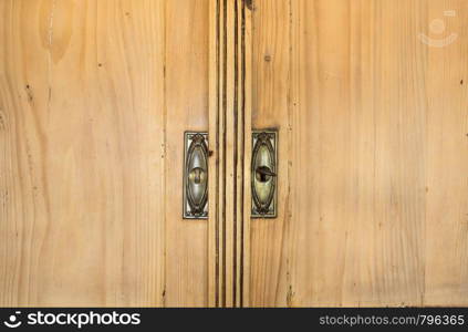 Closeup of vintage brown closet doors, vintage design beauty close-up. Closeup of vintage brown closet doors, vintage design beauty