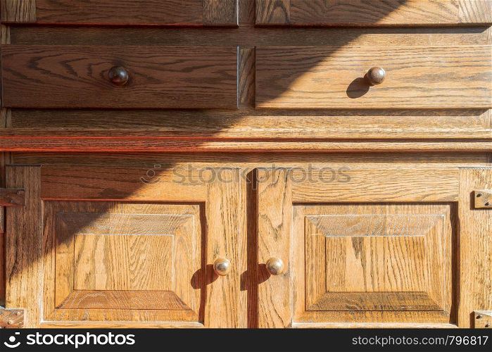 Closeup of vintage wooden closet, brown antique old with shadows close-up. Closeup of vintage wooden closet, brown antique old with shadows