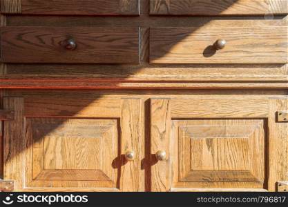 Closeup of vintage wooden closet, brown antique old with shadows close-up. Closeup of vintage wooden closet, brown antique old with shadows