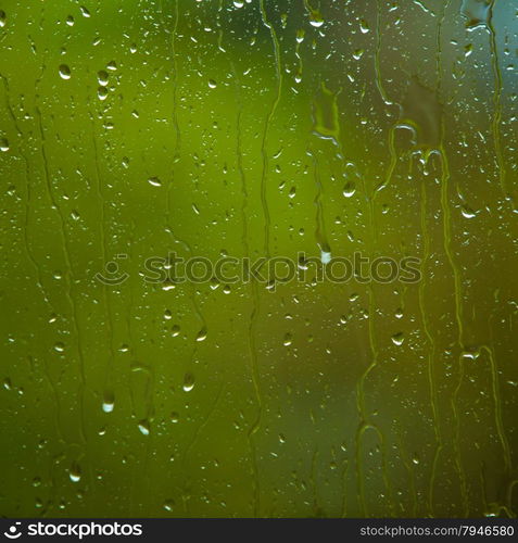 Closeup of water drops droplets raindrops on glass window as background texture. Rain. Square format.