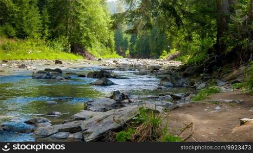 Closeup of wet rocks and calm flowing water on the beautiful mountain river flowing through pine forest.. Closeup of wet rocks and calm flowing water on the beautiful mountain river flowing through pine forest