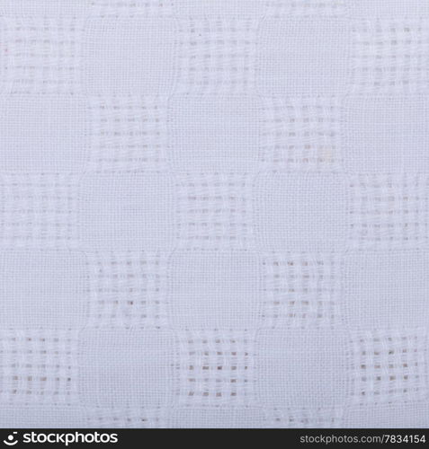 Closeup of white fabric textile as background texture pattern backdrop. Square format. Macro.