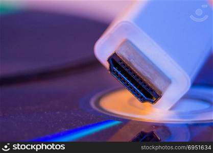 Closeup of white HDMI cable with it&rsquo;s reflection on blank disc.