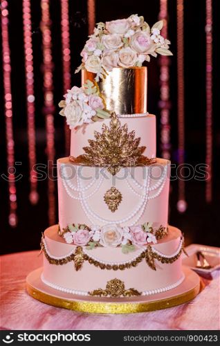 Closeup of white wedding cake with flowers. Wedding ceremony.. Closeup of white wedding cake with flowers. Big wedding cake. Decor trends. Wedding ceremony.