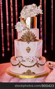 Closeup of white wedding cake with flowers. Wedding ceremony.. Closeup of white wedding cake with flowers. Big wedding cake. Decor trends. Wedding ceremony.