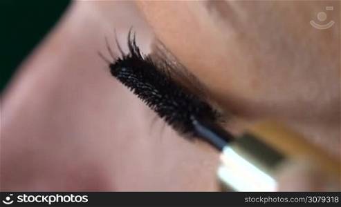 Closeup of woman&acute;s eye applying mascara - video in slow motion