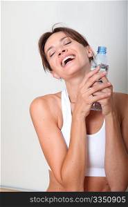 Closeup of woman drinking water after exercising