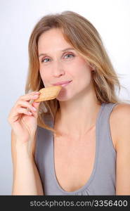 Closeup of woman eating cookie