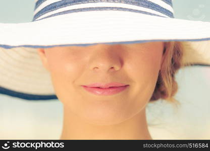 Closeup of woman girl head in striped hat. Summer fashion.. Closeup of fashion woman in striped summer hat.