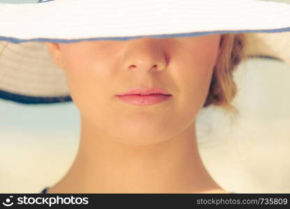 Closeup of woman girl head in striped hat. Summer fashion.. Closeup of fashion woman in striped summer hat.