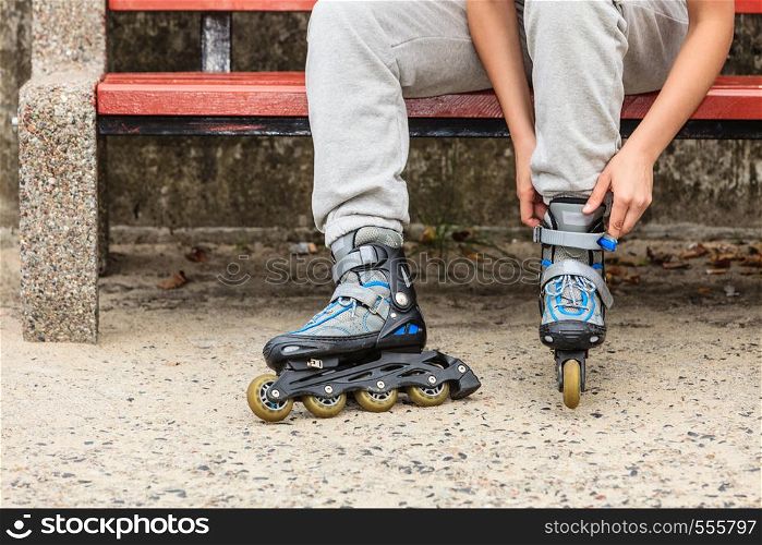 Closeup of woman girl putting on roller skates outdoor.. Woman putting on roller skates outdoor.