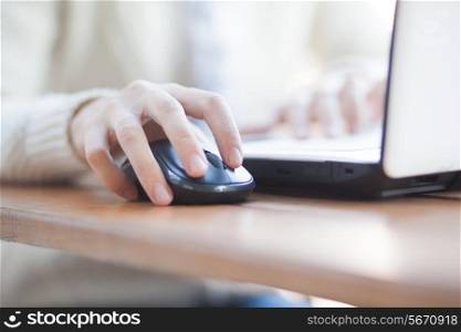 Closeup of woman hand clicking mouse outdoor