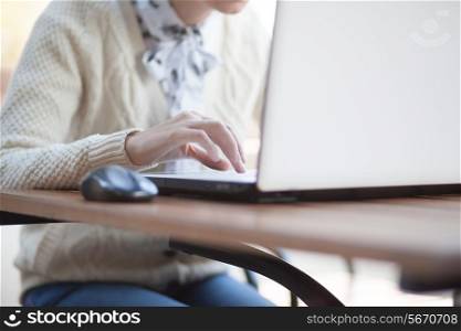 Closeup of woman hand typing on notebook outdoor