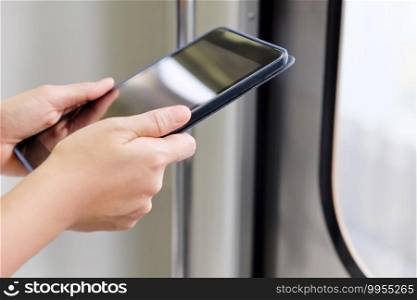 closeup of woman hand  using digital tablet in skytrain
