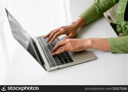 Closeup of woman hand working at home office and typing on keyboard. Business and technology theme. People lifestyles and Office occupation concept. Accounting and Computer. Social distancing theme
