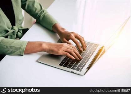 Closeup of woman hand working at home office and typing on keyboard. Business and technology theme. People lifestyles and Office occupation concept. Accounting and Computer freelance programming theme
