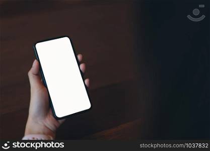 Closeup of woman holding a smartphone, mock up of blank screen. using cell phone on cafe. Technology for communication concept.