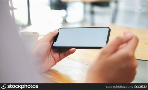 Closeup of woman holding blank screen smartphone. Copy space and mockup.