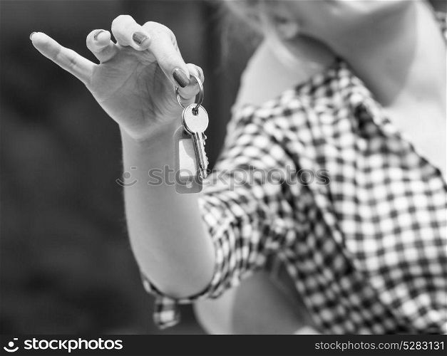 Closeup of woman holding house keys in arm