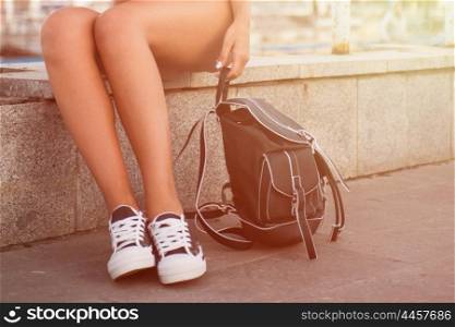 closeup of woman legs in white gumshoes, outdoor shot