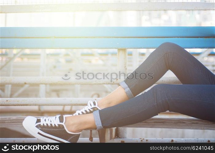 closeup of woman legs in white gumshoes, outdoor shot