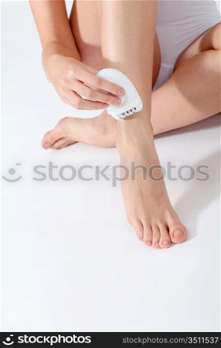 Closeup of woman shaving her legs