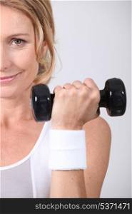 Closeup of woman with dumbbell