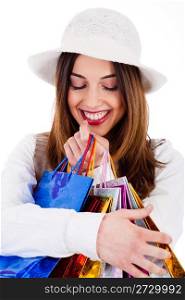 Closeup of women holding her shopping bags very happily on a white background