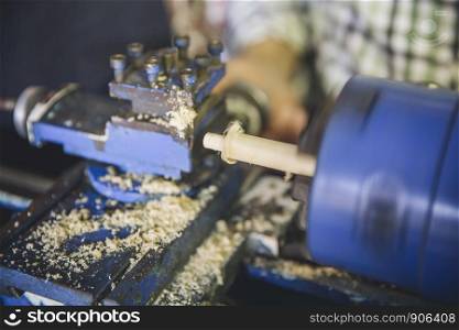 Closeup of wooden lathe working in a carpentry. Closeup of wooden lathe