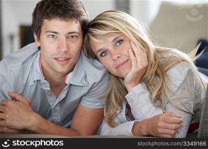 Closeup of young couple laying on couch