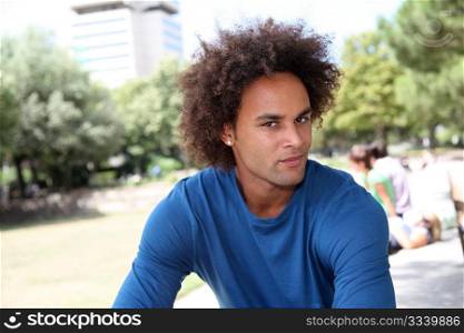 Closeup of young man sitting in a park