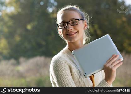Closeup of young smart woman with tablet outdoors. Distance education.