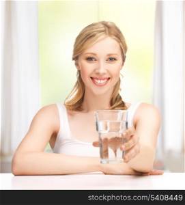 closeup of young smiling woman with glass of water