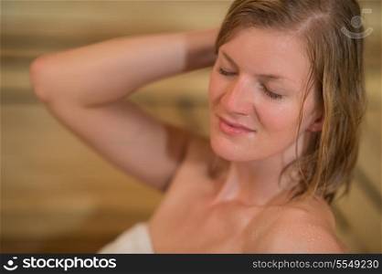 Closeup of young woman sweating in sauna